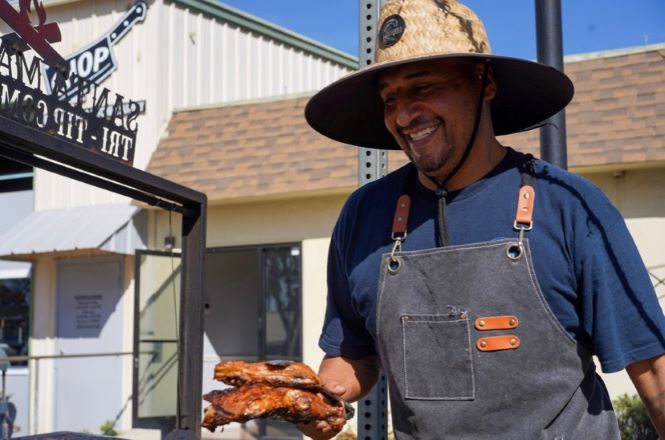 man cooking santa maria style barbeque